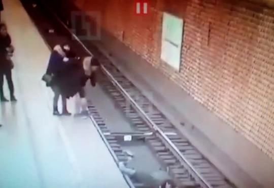 Metroda kişi qadını qatarın altına itələdi - VİDEO